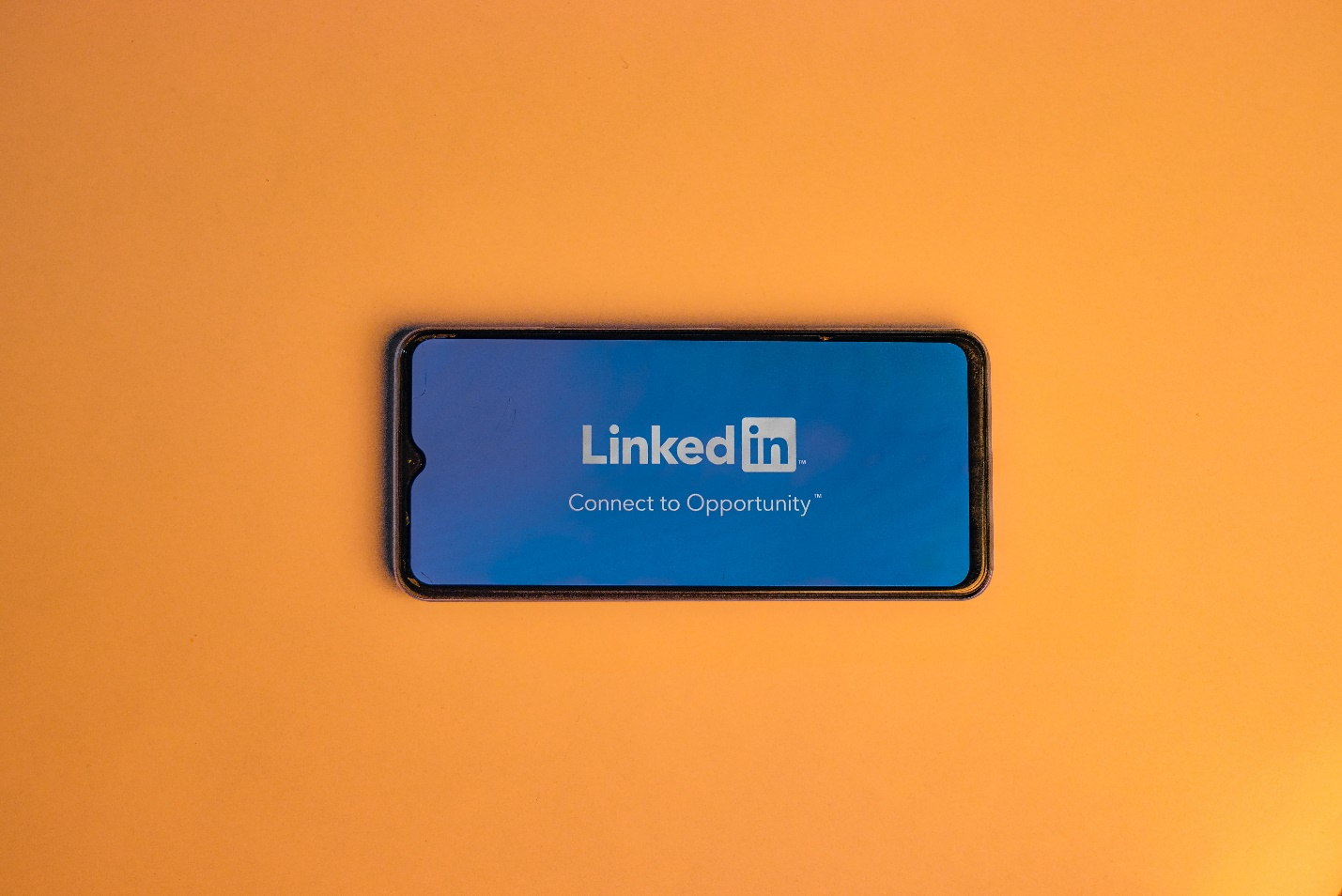 A phone shows the LinkedIn screen saying: Connect to Opportunity on an orange background